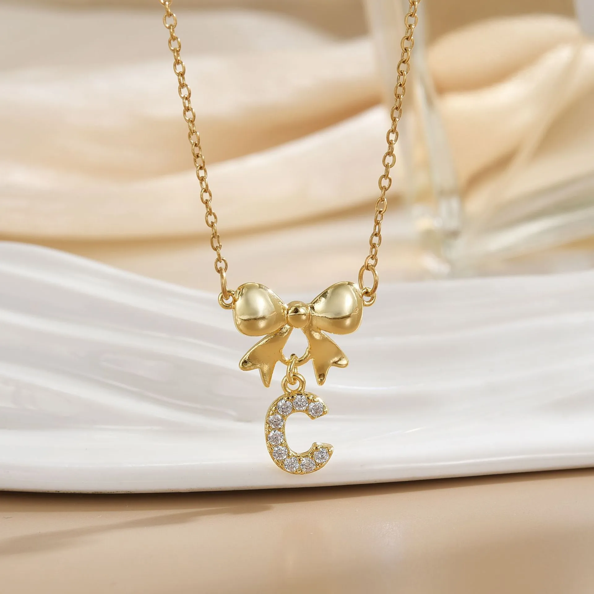 Simple 26 Letters Inlaid Zircon Bow Necklace Women's Simple High Sense Ornament Titanium Steel No Fading display picture 2