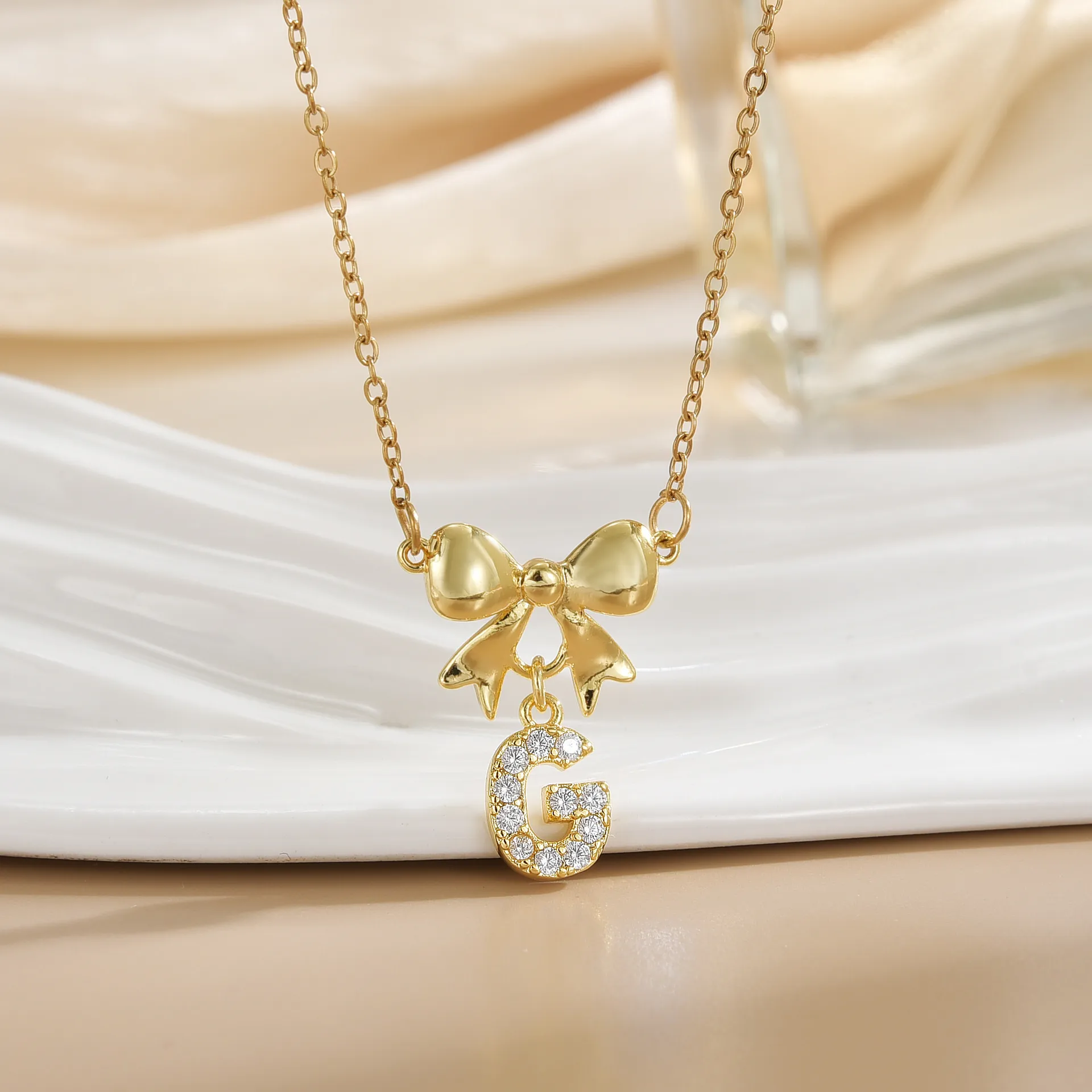 Simple 26 Letters Inlaid Zircon Bow Necklace Women's Simple High Sense Ornament Titanium Steel No Fading display picture 3